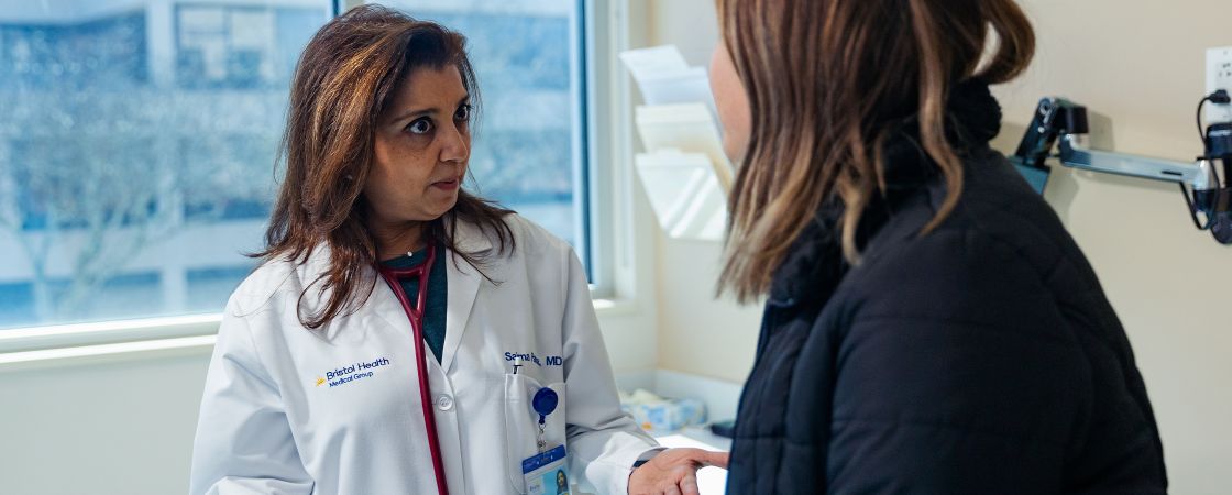 Doctor speaking to patient in exam room