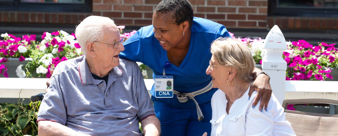 Bristol Health nurse spending time with a patient and their visitor