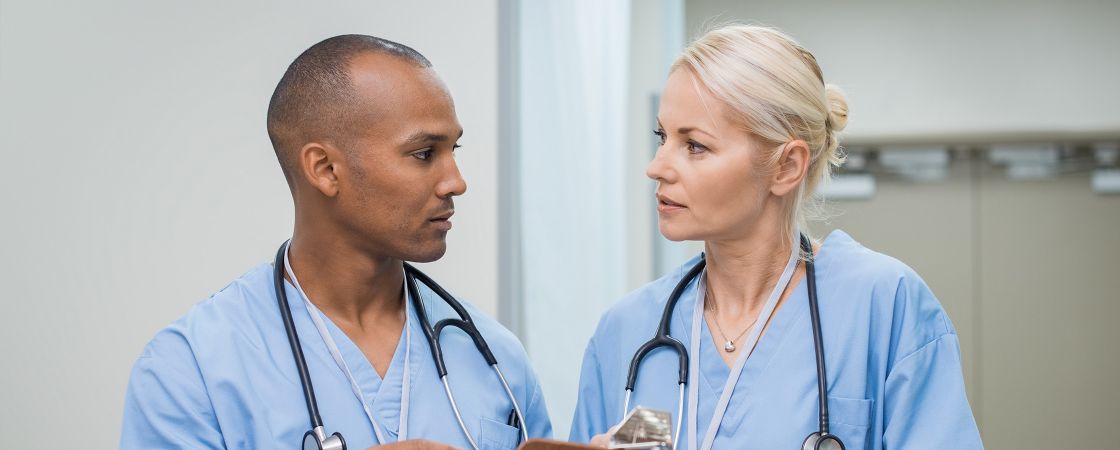 Two nurses speaking to eachother