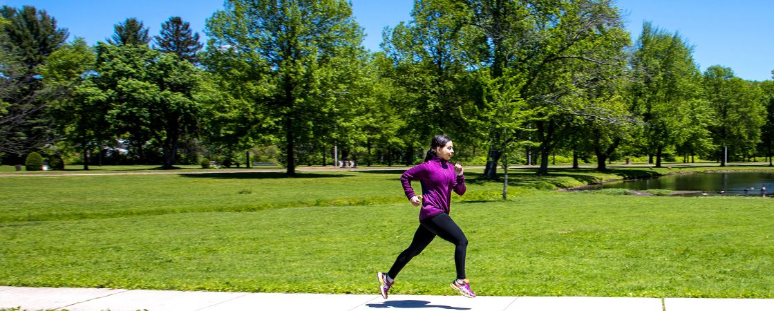 Woman running on side walk