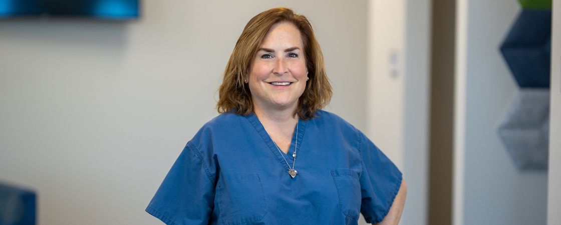 Nurse with hand on hip smiling