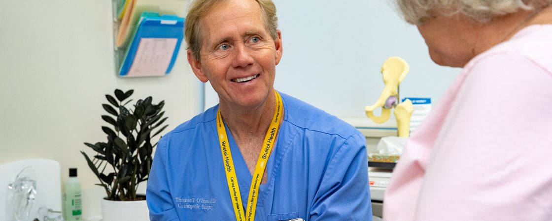 Bristol Health orthopedic surgeon consulting with patient in office