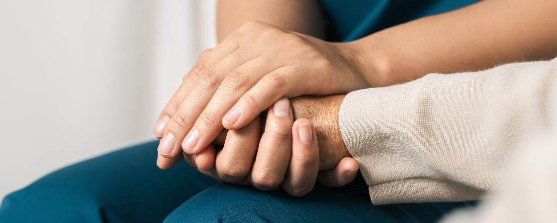 Nurse holding patients hand