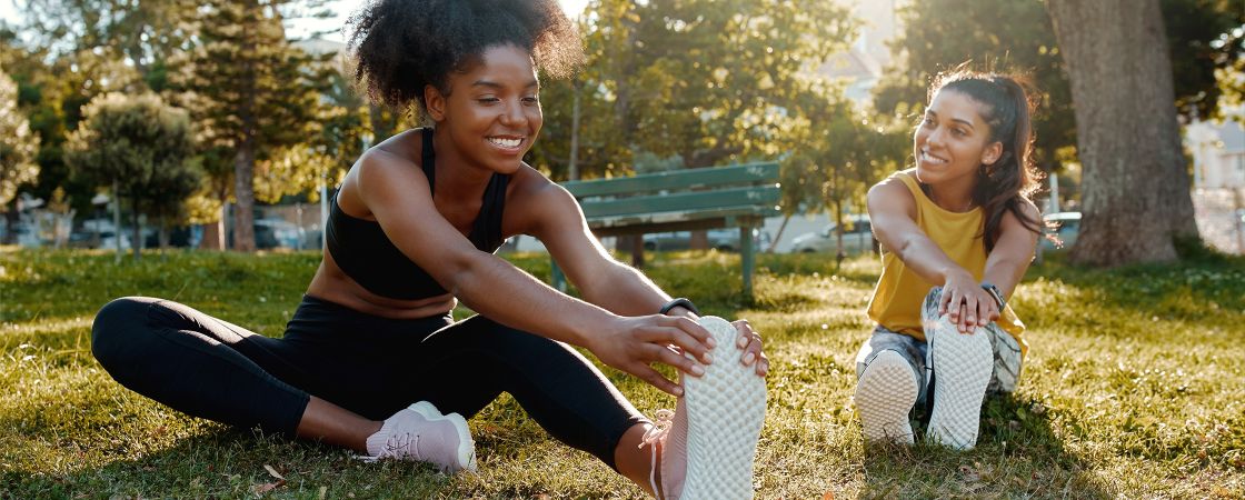 Two girls stretching in park