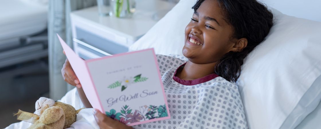 Bristol Health patient smiling while looking at get well card