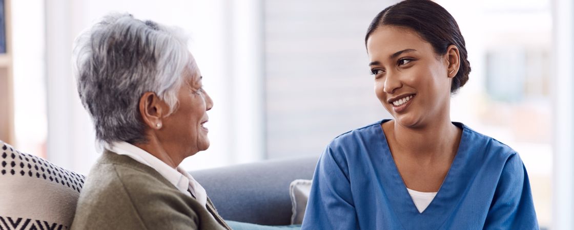 Nurse and elderly patient having a conversation