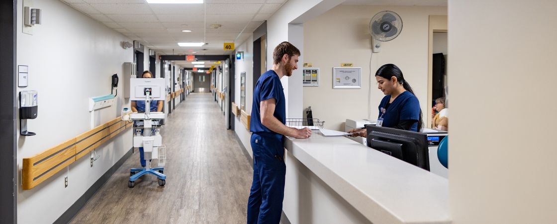 Hospital hallway with working nurses