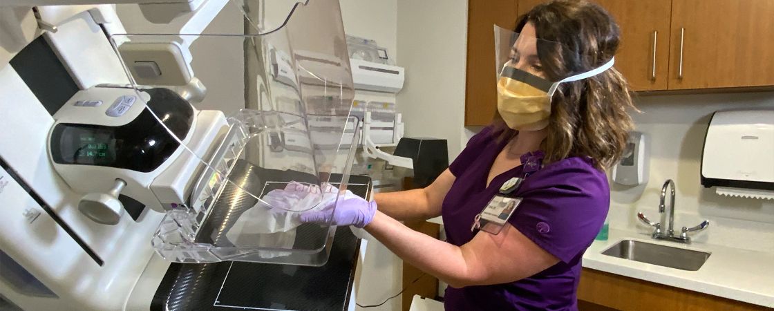 Nurse cleaning hospital equipment