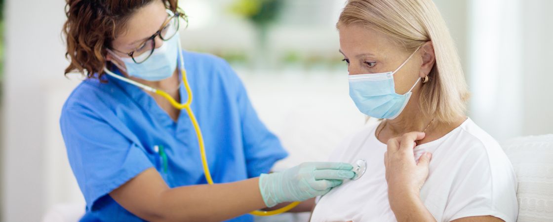 Doctor speaking to patients wearing masks