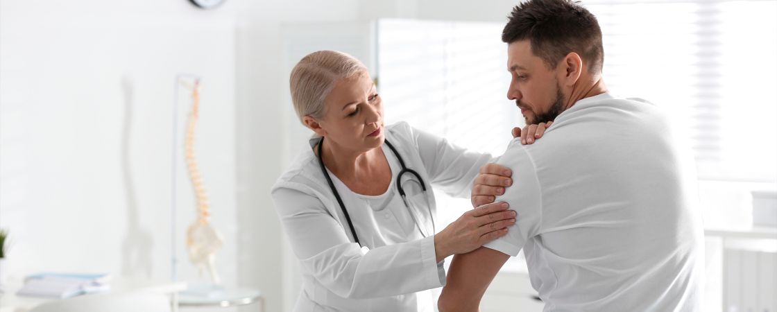 Doctor examining patients shoulder