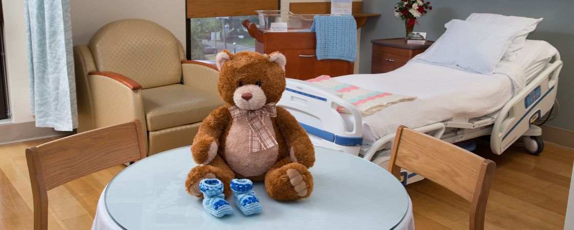 Birthing room with teddy bear on table