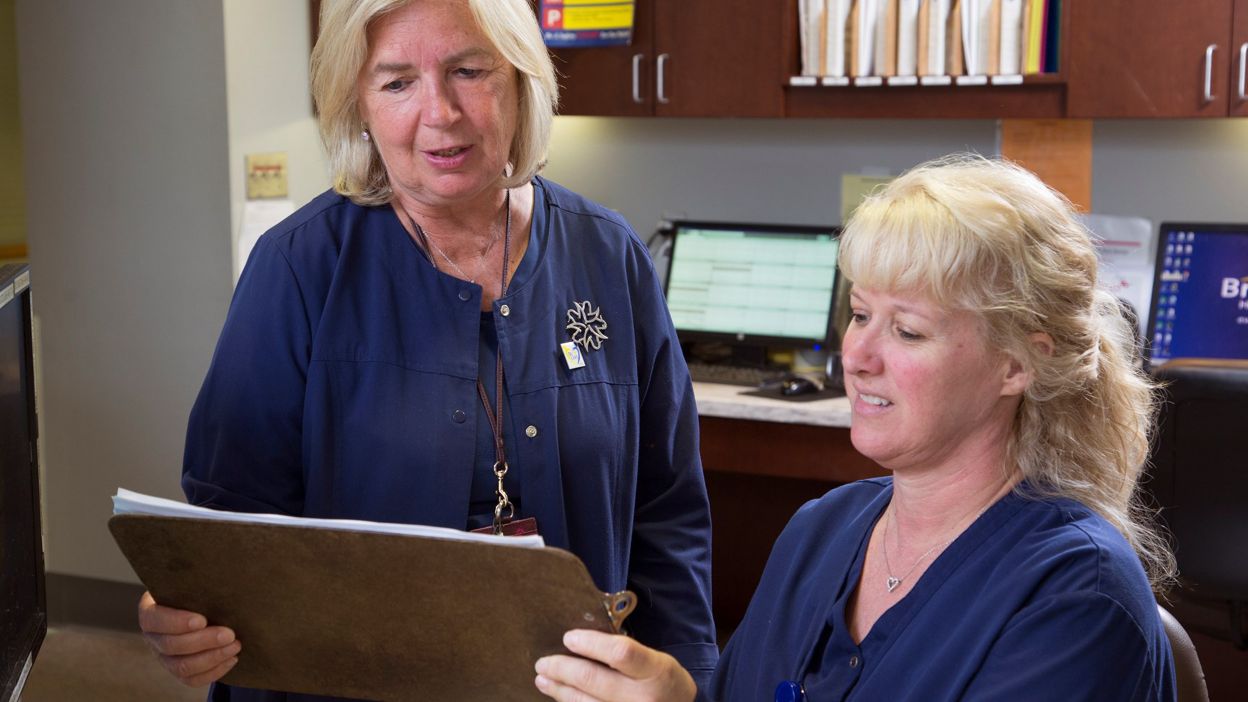 Bristol Health employees looking at clipboard