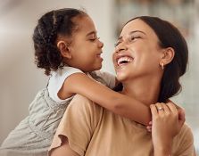 Mother and daughter laughing and hugging each other