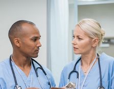 Two nurses speaking to eachother