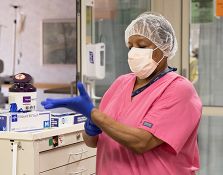 Nurse putting gloves on