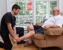 Nurse holding hand of elderly patient