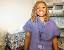 Smiling nurse in supply room