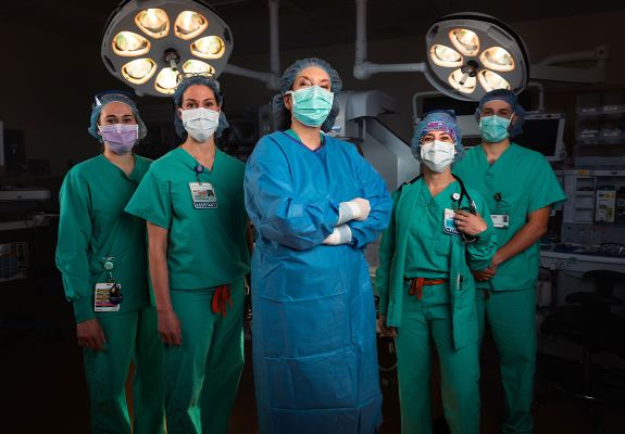 Group of surgeons standing in front of equipment