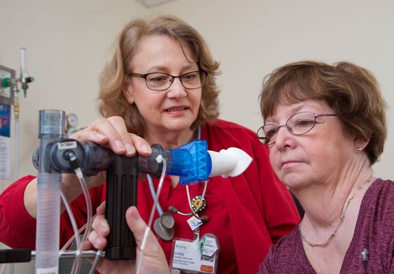 Nurse helping patient with breath test