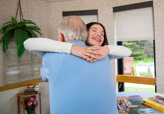 Patient hugging a family member