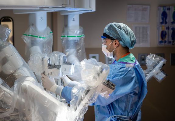 Surgeon working with equipment