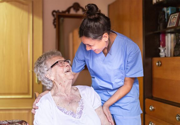 Nurse hugging elderly patient