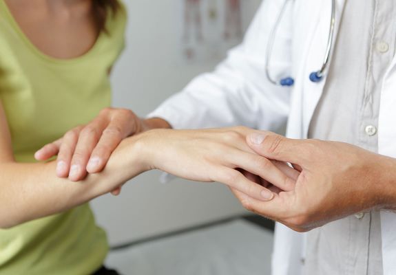 Doctor holding patients wrist