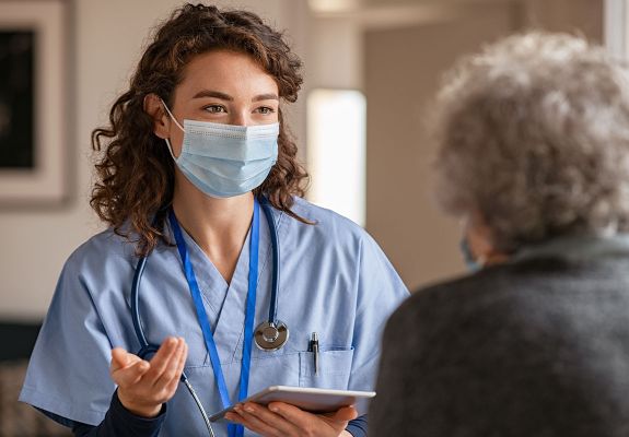 Nurse speaking to patient