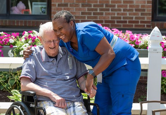 Nurse hugging elderly patient