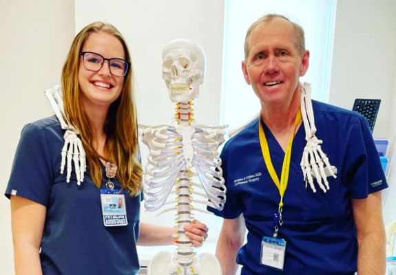 Nurses posing next to skeleton