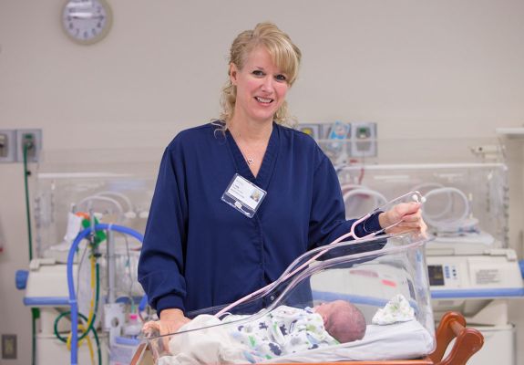 Nurse with baby in hospital