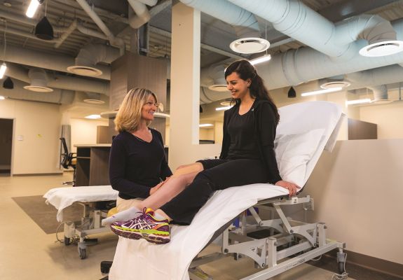 Doctor examining patient's knee
