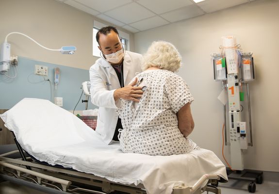 Doctor using stethoscope on patient