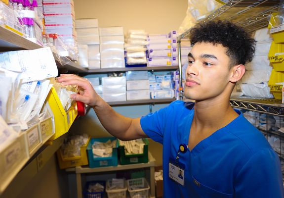 Nurse looking through supply closet