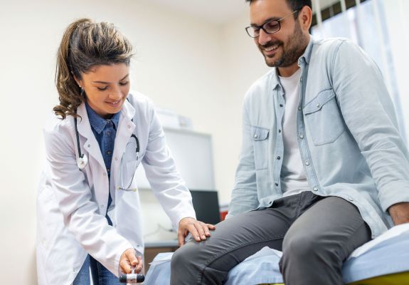 Doctor testing patients reflexes