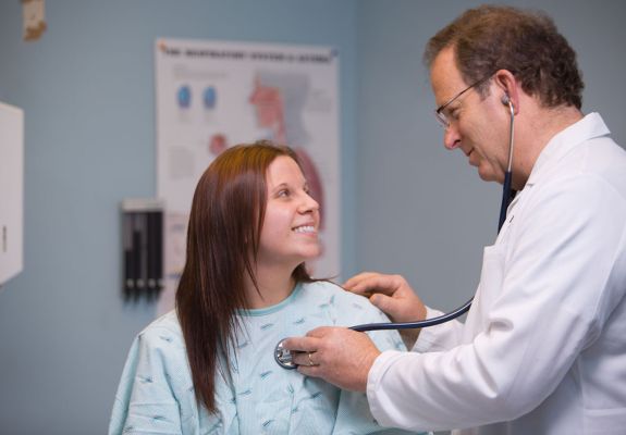 Doctor listening to the patient's heartbeat with a stethoscope