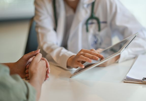 Doctor showing patient tablet