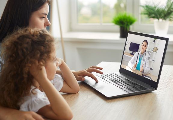 Mother and daughter having a telehealth consultation with the doctor on a laptop