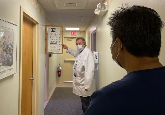 Doctor pointing to eye chart