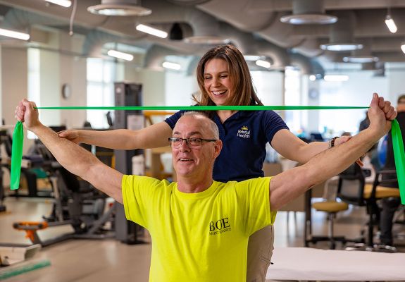 Bristol health employee guiding patient using elastic band